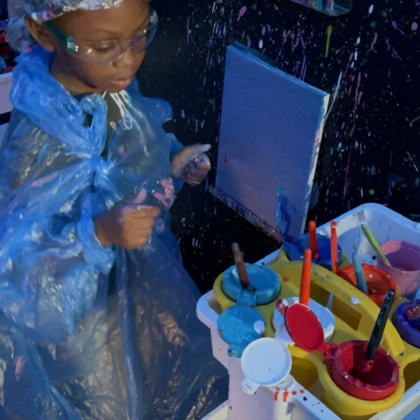 a group of people sitting at a table with a birthday cake