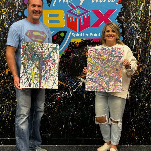 a group of people standing in a parking lot